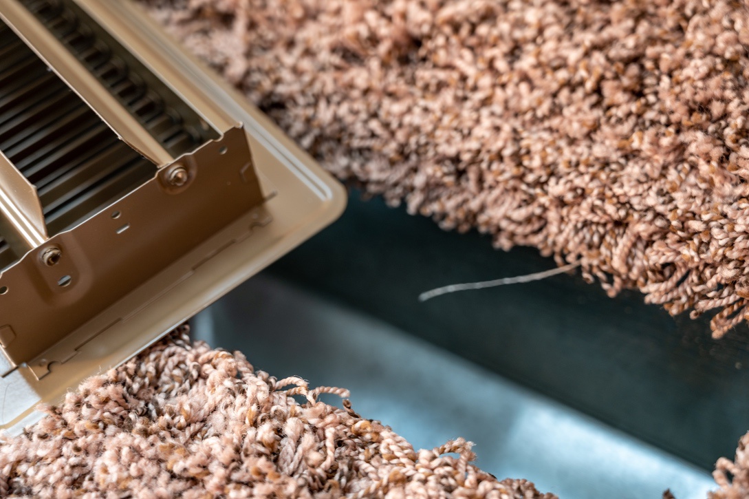 Air vent removed from floor with carpet in Nebraska home for cleaning before winter