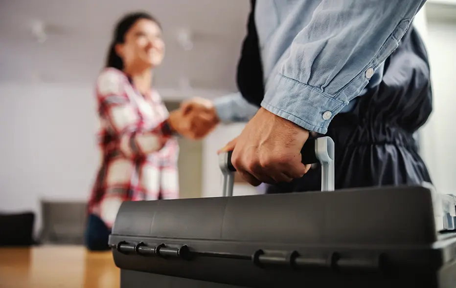 Man holding briefcase shaking women's hand