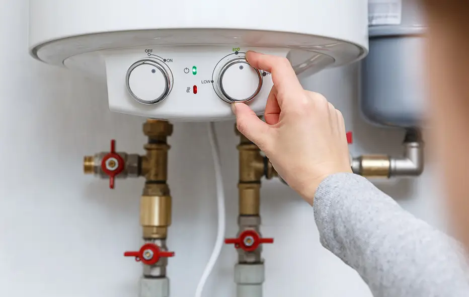 Homeowner adjusting the heat on a boiler