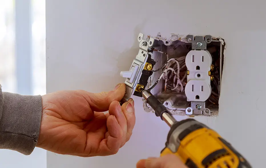 Electrician installing a light switch